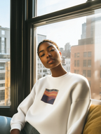 Cream crewneck sweatshirt with “OLDER THAN DIRT.” graphic, worn by woman indoors