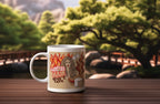 White ceramic coffee mug with flaming red-haired cat graphic and campfire text