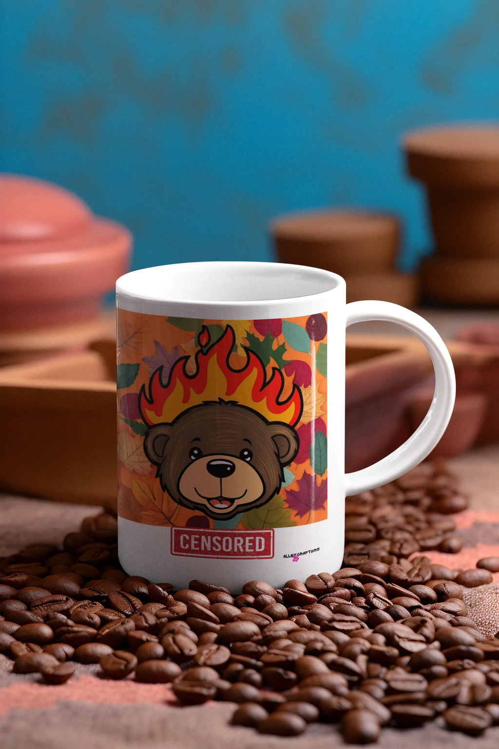 White ceramic bear mug with flames artwork and red “CENSORED” label, angled view.
