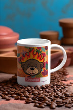 White ceramic bear mug with flames artwork and red “CENSORED” label, angled view.