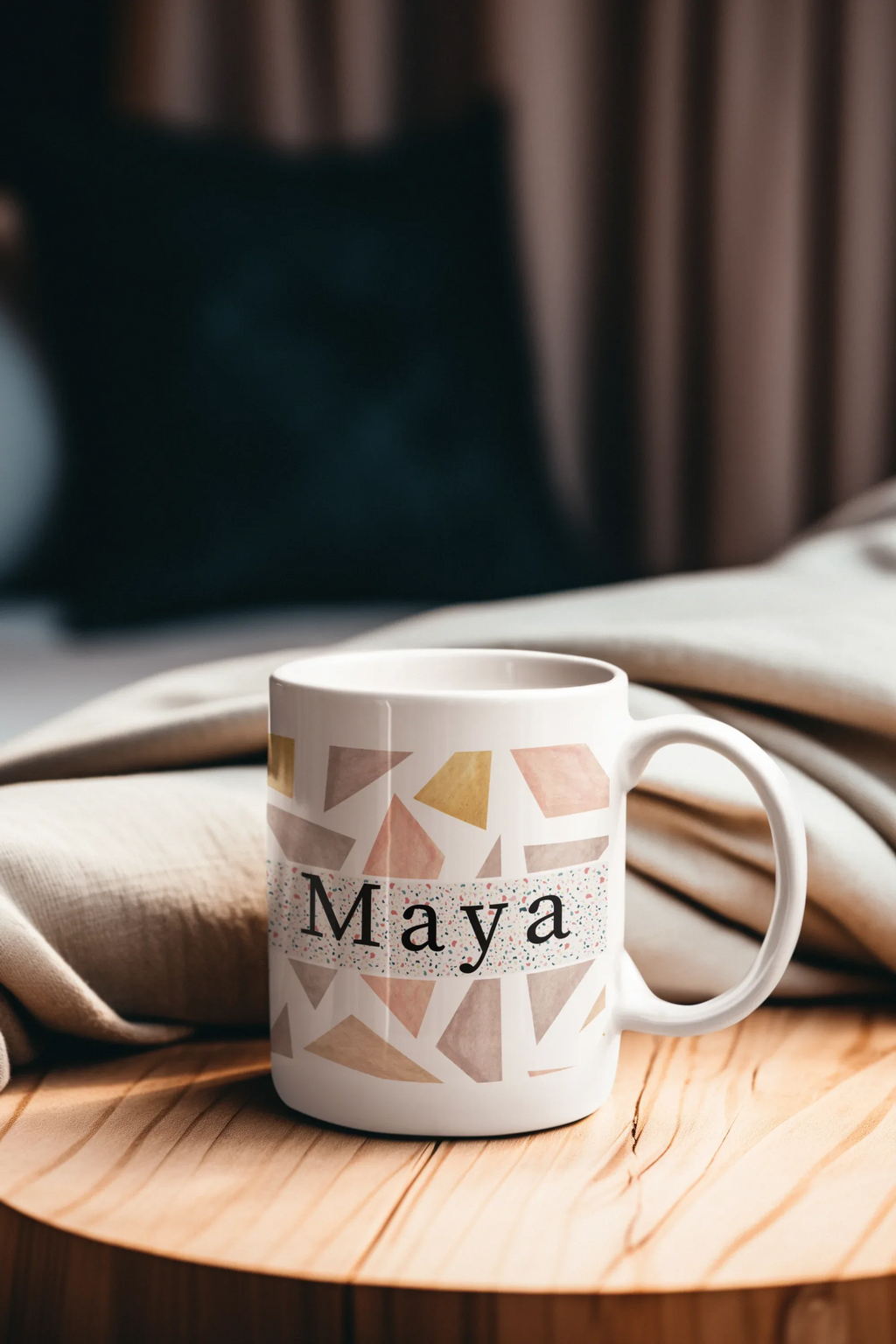 White 11oz mug with geometric triangles and name Maya printed on front