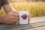 White ceramic mug with “ALEC” name print and “Cricket Legend” text, held on wooden bench