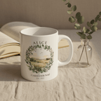 White ceramic coffee mug on tablecloth with countryside wreath print and name "ALICE"