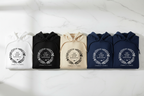 Assorted couples hoodies laid flat with honeymoon wreath graphic and 'Still waiting' text