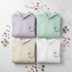 Four pullover yoga hoodies in lavender, mint, cream, and white with chest logo