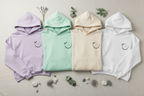 Pastel unisex yoga hoodies in lavender, mint, cream, and white with chest logo