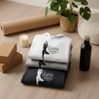 Stack of white and dark navy hoodies with yoga silhouette logo on the chest.