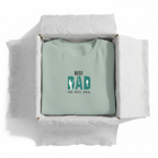 Mint teal T-shirt in a box with “Best Dad” retro graphic print on the chest