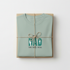 Mint teal T-shirt wrapped in a gift box with “Best Dad” retro graphic print