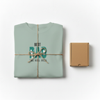 Mint teal T-shirt folded with “Best Dad” retro graphic print on chest