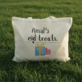 White cotton tote bag with “Amal’s eid treats” text and gift icons