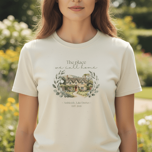 White crew-neck T-shirt close-up with “The place we call home” house wreath print.