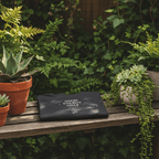 Dark crew-neck T-shirt on a wooden bench with “GOOD ENERGY ONLY” chest graphic