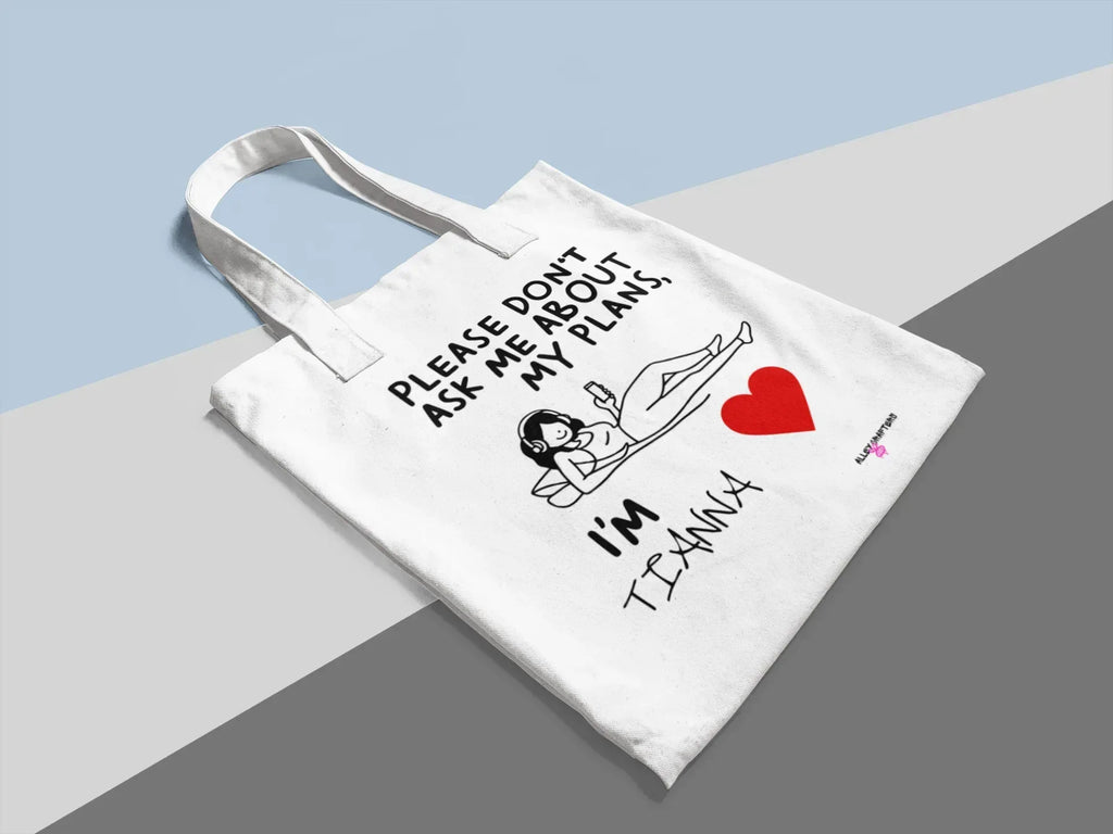 White canvas tote bag with diagonal layout, “Please don’t ask me about my plans” and red heart