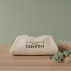 Light sand unisex sweatshirt with 'Annoying but Essential' slogan on front
