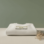 Light sand unisex sweatshirt folded on a surface with 'Annoying but Essential'