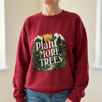 Antique cherry red unisex sweatshirt with “Plant More Trees” nature graphic on chest.
