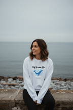 White crewneck sweatshirt with 'Keep the ocean blue' whale graphic