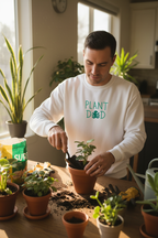 White crewneck sweatshirt worn by a man, “PLANT DED” plant graphic
