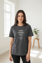 Dark gray t-shirt worn by a model with “GOOD ENERGY ONLY” sunburst graphic on front.