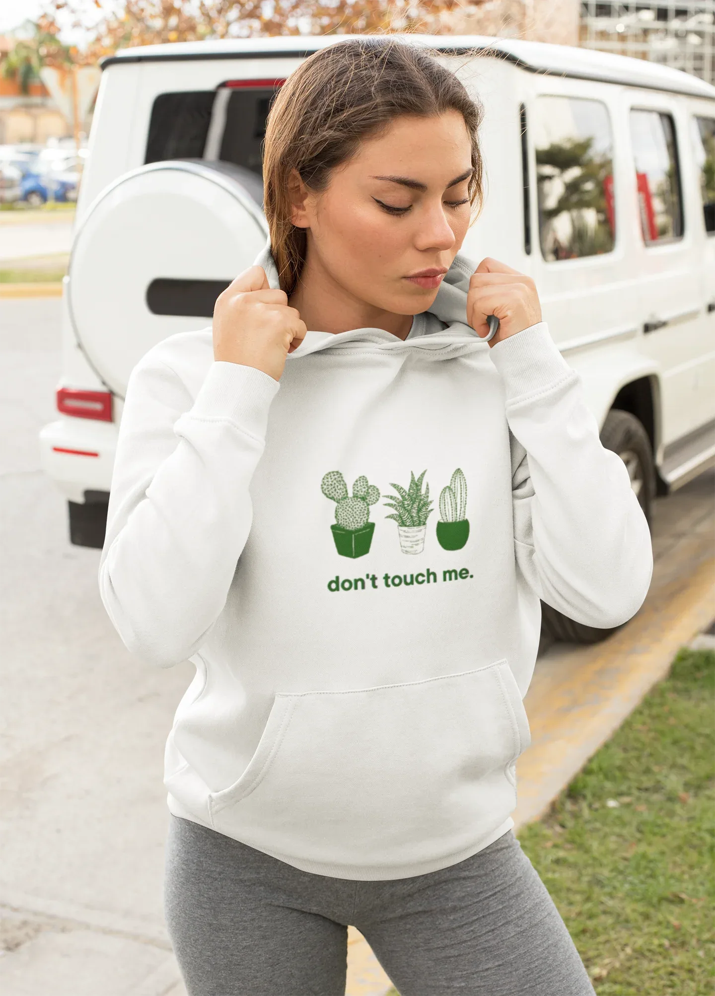 White hoodie with green cactus print and "don't touch me." text; kangaroo pocket