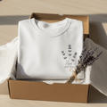 White t-shirt with lavender sprig graphic and handwritten-style 'EST.2021' text