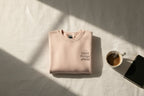 Light pink crewneck sweatshirt with small chest logo