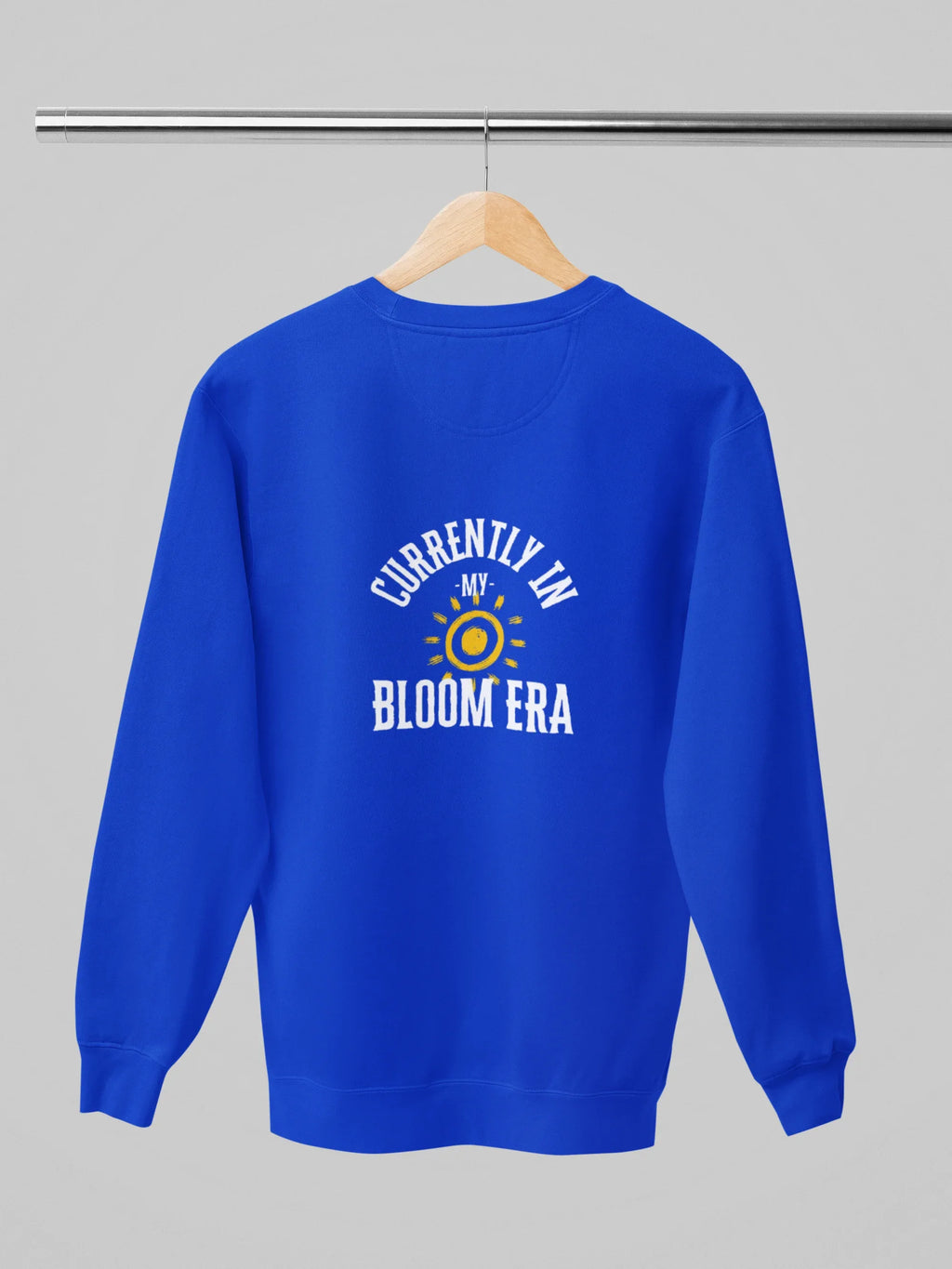 Royal blue sweatshirt with “Currently in My Bloom Era” graphic on the back.