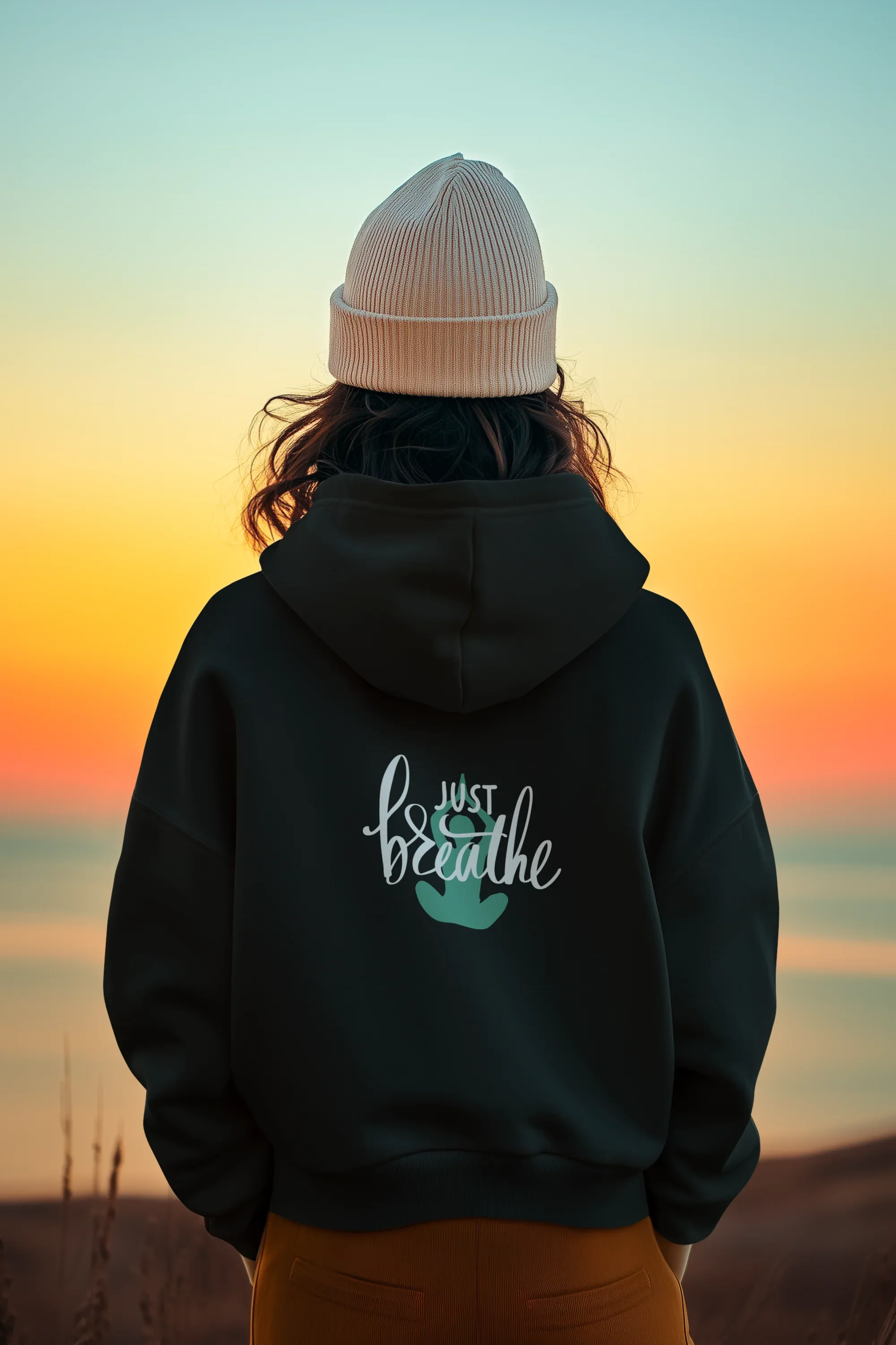 Black hoodie with kangaroo pocket and 'Just Breathe' logo on back