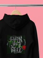 Black unisex hoodie with hood, front pocket, and Faith over Fear rose chest graphic