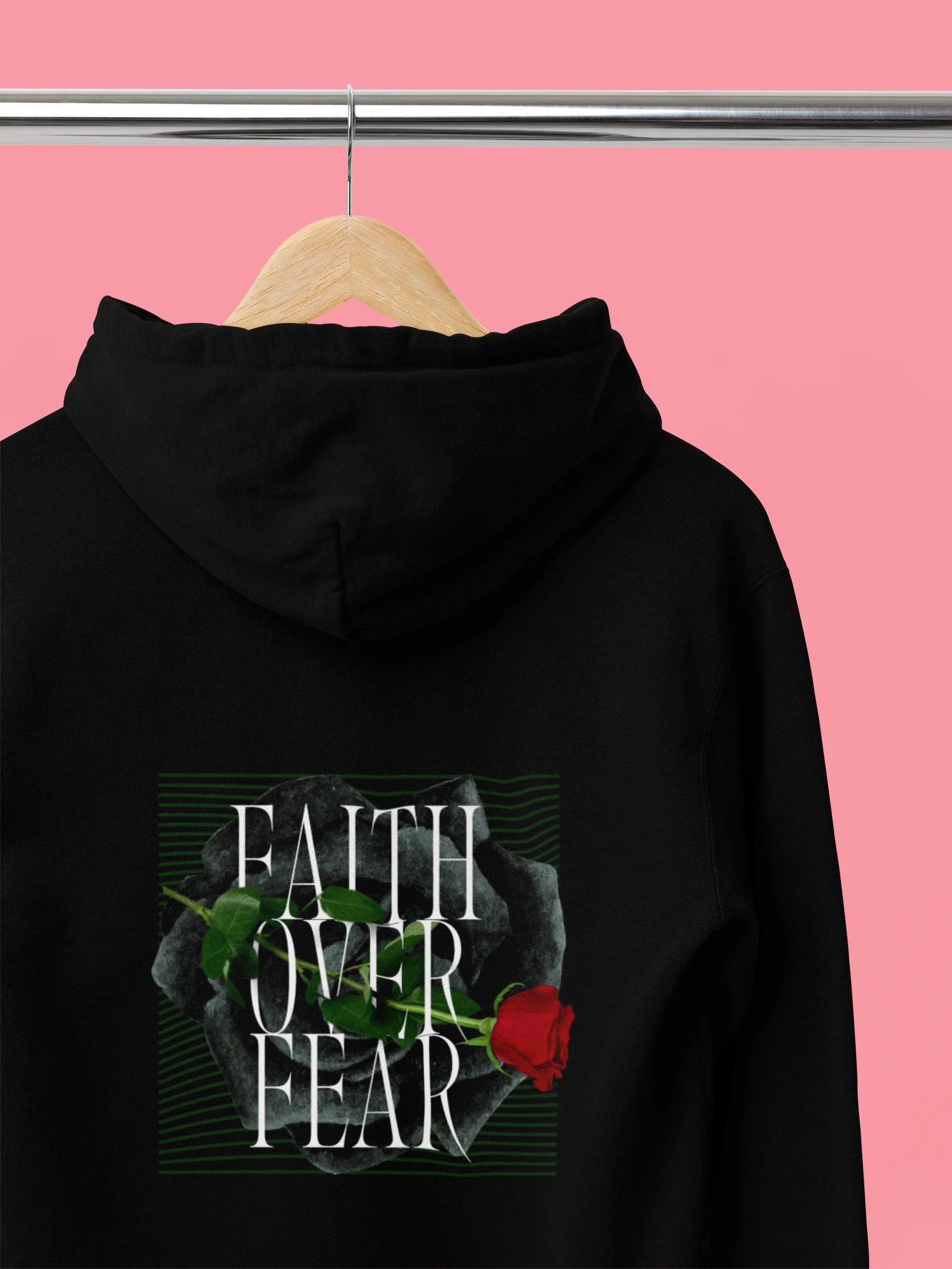 Black unisex hoodie with hood, front pocket, and Faith over Fear rose chest graphic