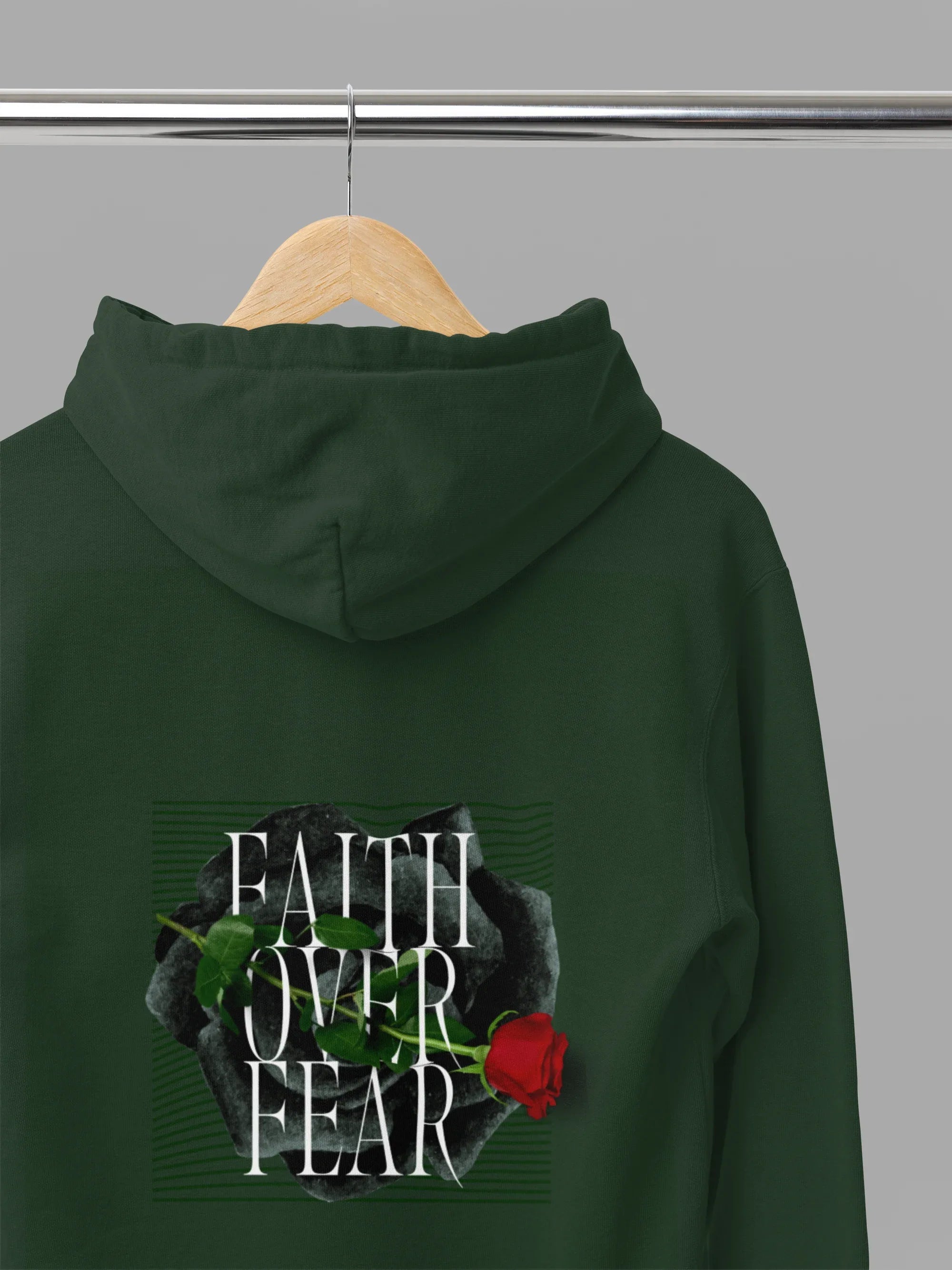 Forest green unisex hoodie with hood, front pocket, and Faith over Fear rose back graphic
