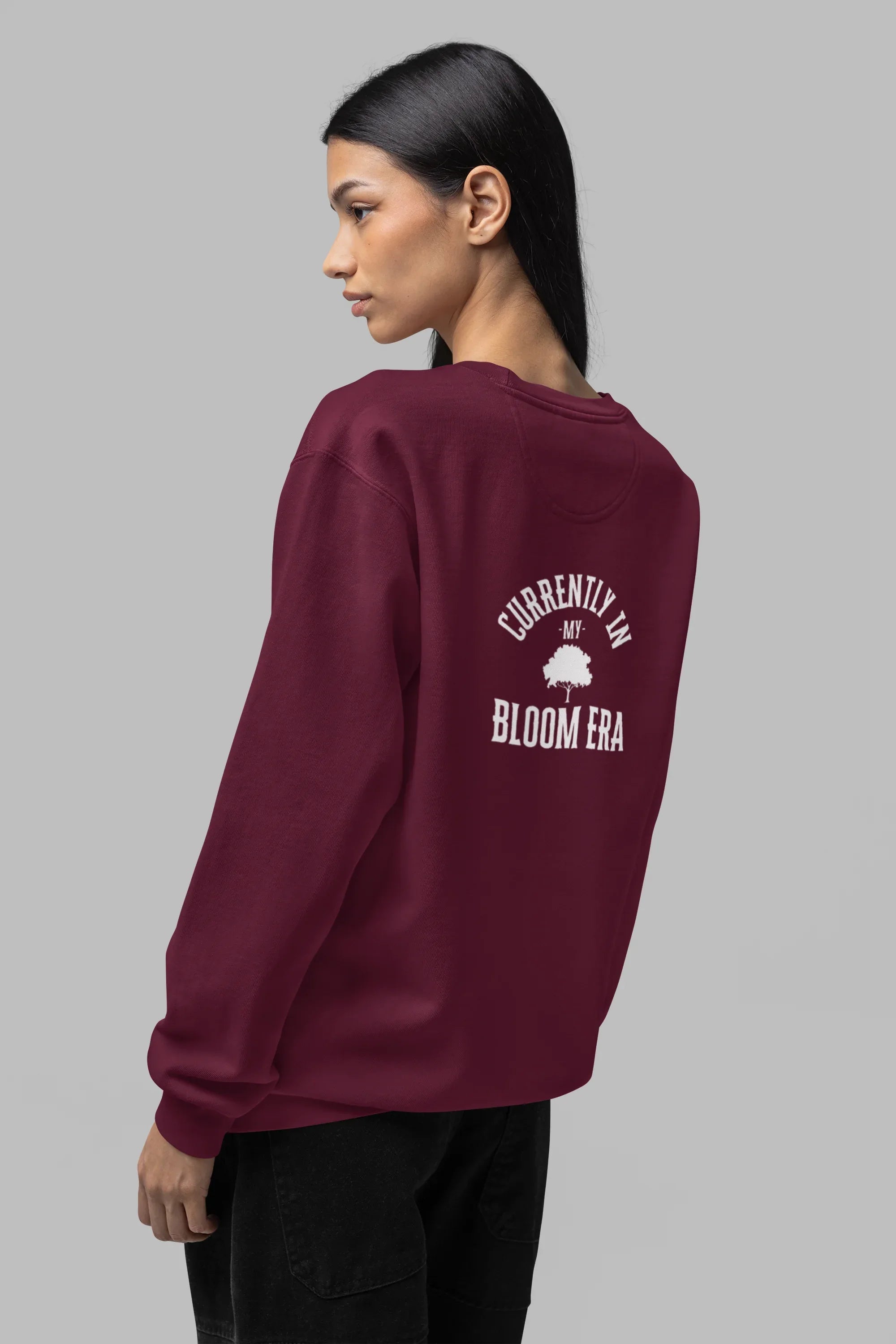 Burgundy crewneck sweatshirt with 'Bloom Era' back graphic