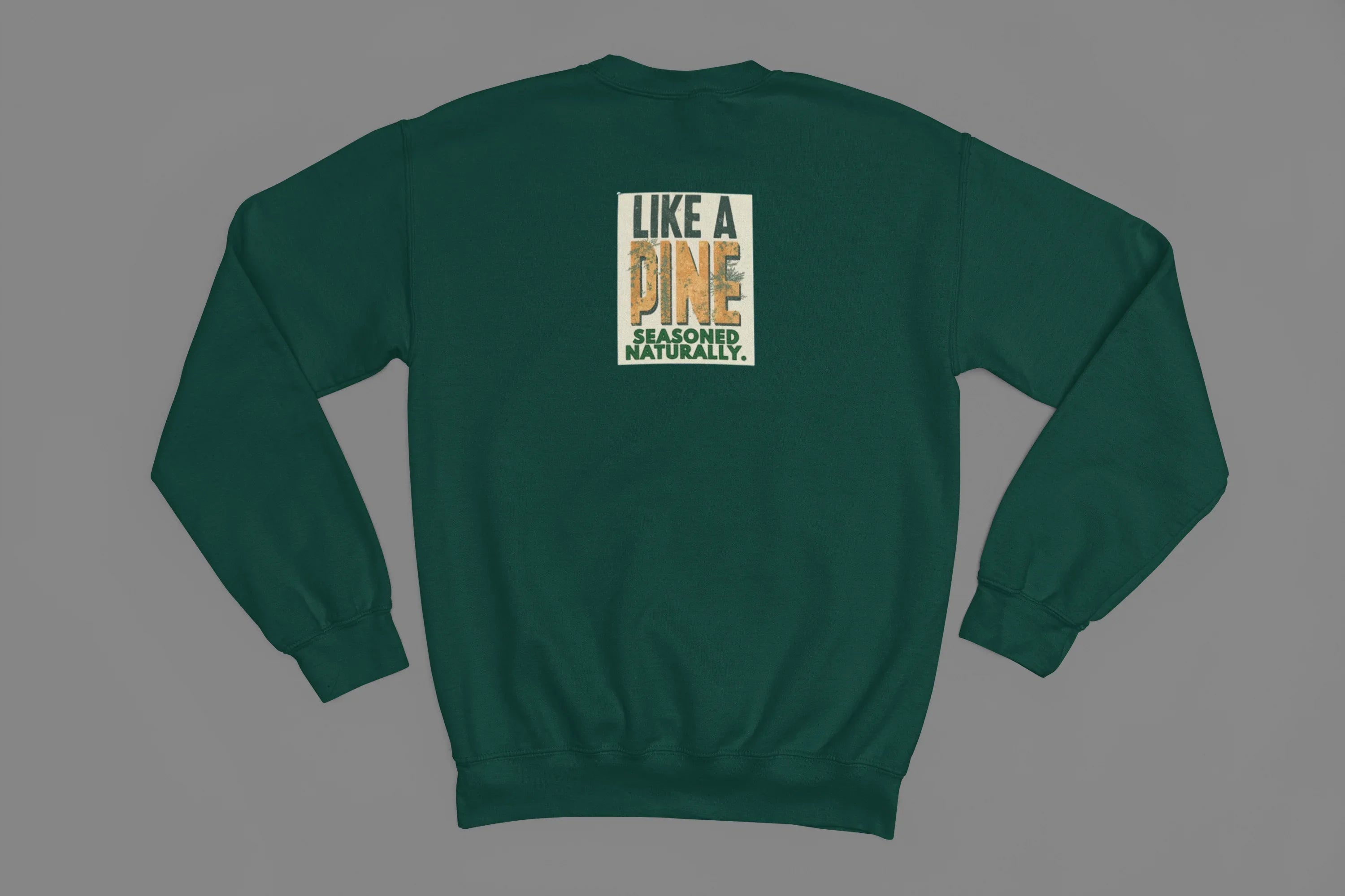 Green sweatshirt back view with small square “Like a Pine” logo centered