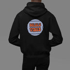 Black hoodie worn with hood down; circular "DELULU VIBES" graphic on back