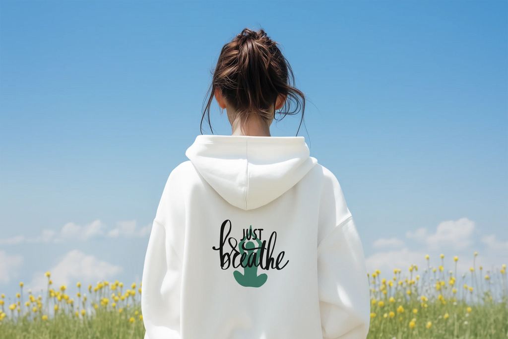 White Just Breathe hoodie with hood and chest graphic on back view