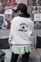 White sweatshirt with crew neck and "Currently in My Bloom Era" back text print