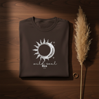 Dark brown graphic T-shirt with sun-and-moon emblem and 'wild soul Bea 2026'