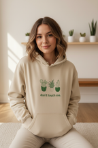 Beige sand hoodie with cactus graphic and “don’t touch me.” text on the chest