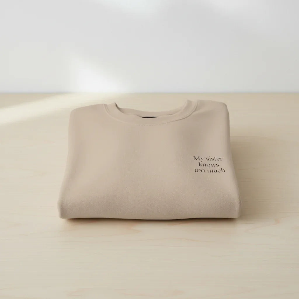 Cream crewneck sweatshirt with small chest text design