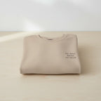 Cream crewneck sweatshirt with small chest text design