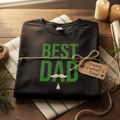 Black men’s graphic T-shirt with green “BEST DAD” print across chest