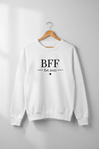 White personalised sweatshirt on hanger with front text "BFF" and Est.2023