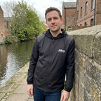 Black hooded lightweight windbreaker jacket with Alley logo, front