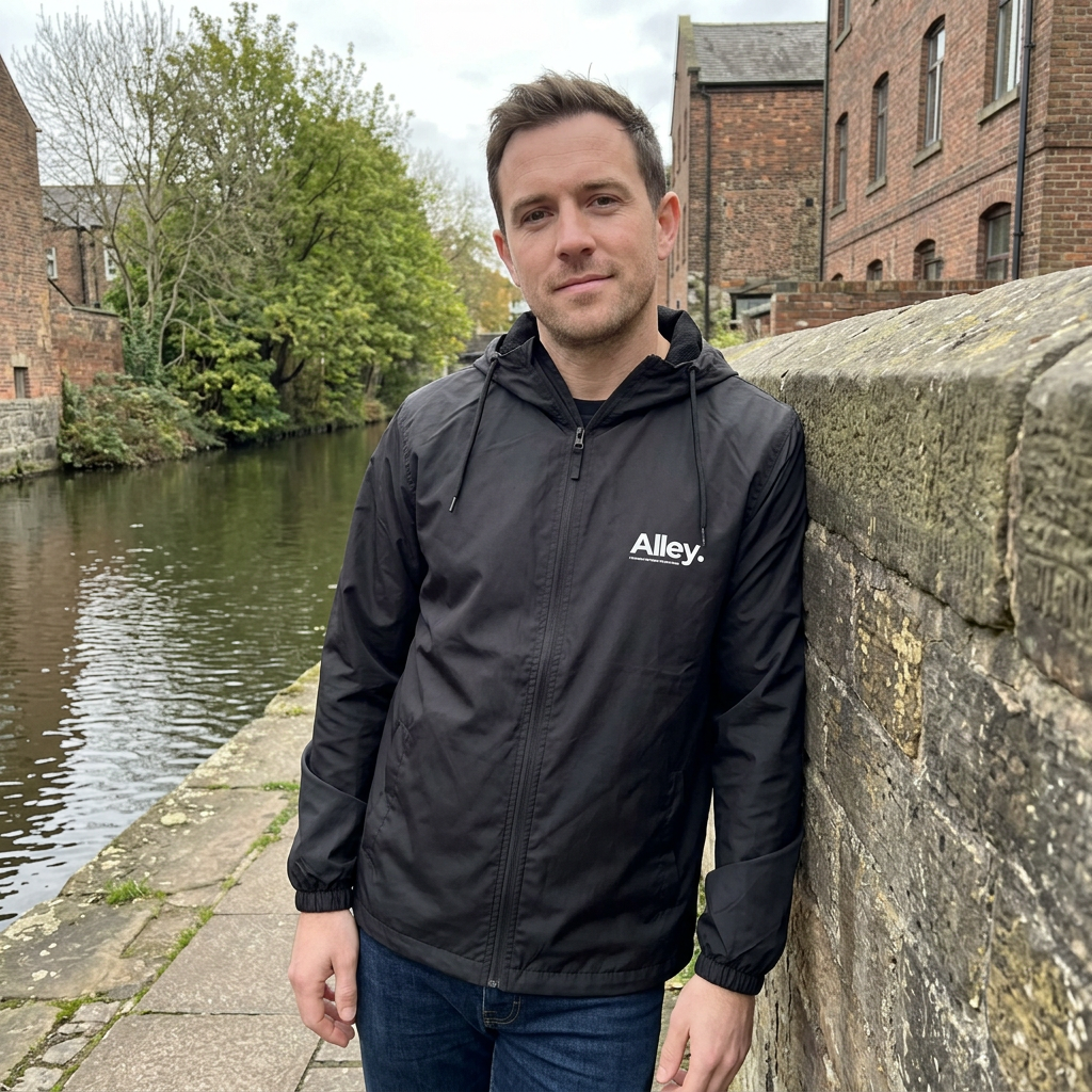 Black hooded lightweight windbreaker jacket with Alley logo, front