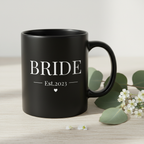 Black ceramic mug with handle, BRIDE Est.2023 text and heart on front