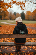 Black mindfulness hoodie with “Just breathe” slogan and hand heart graphic on back