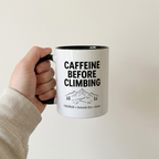 Black climbing mug held against a simple neutral background