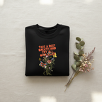 Black crewneck sweatshirt with colorful “Take a Deep Breath” floral graphic on front.