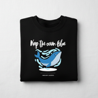 Black crewneck sweatshirt with blue whale graphic and 'Keep the ocean blue' text
